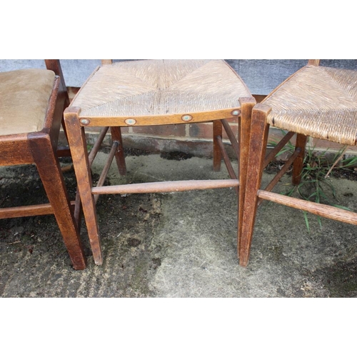 426 - A pair of Arts & Crafts rush seat elbow chairs with triple splat backs