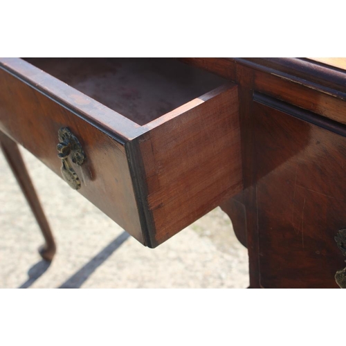 439 - A Georgian design walnut serpentine front dressing/writing table, fitted three drawers, on carved ca... 