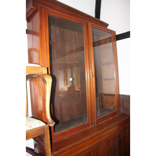 464 - An Edwardian walnut bookcase, the upper section enclosed glazed doors over cupboards, 48