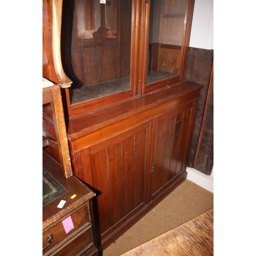 464 - An Edwardian walnut bookcase, the upper section enclosed glazed doors over cupboards, 48