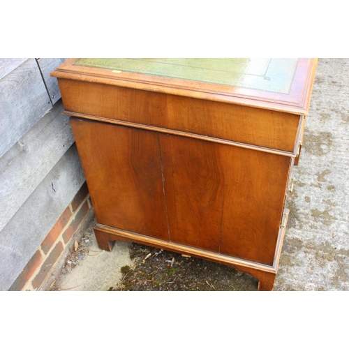 469 - An early 20th century walnut double pedestal desk with green leather tooled lined top over nine draw... 