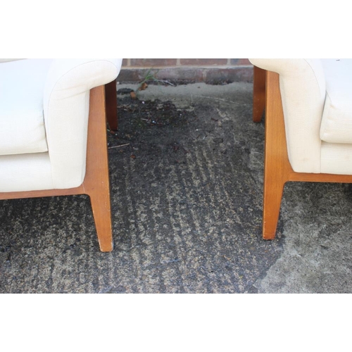 485 - A pair of 1960s Minty oak showframe armchairs, upholstered in a cream linen finish fabric, on splay ... 