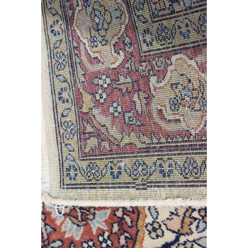 517 - A Kirman rug with all-over flower and tree design and central rust medallion, 72