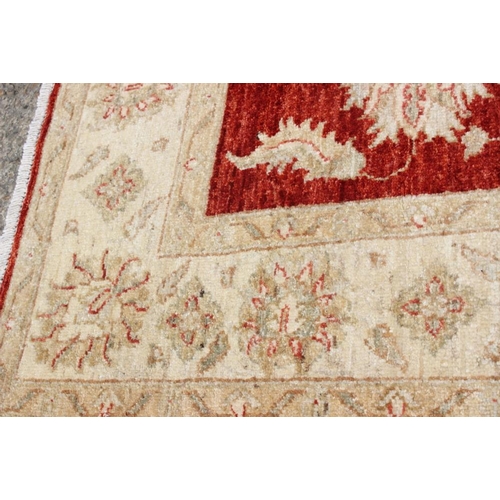 520 - A Kashan Garous floral design rug with multi-borders on a red ground in shades of natural, 52 1/2