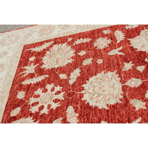 520 - A Kashan Garous floral design rug with multi-borders on a red ground in shades of natural, 52 1/2