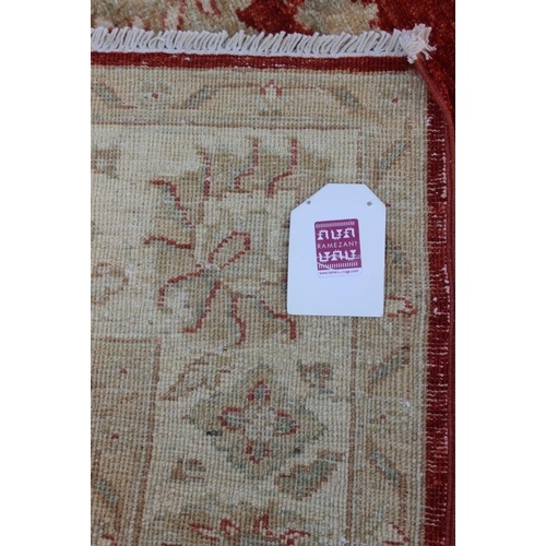 520 - A Kashan Garous floral design rug with multi-borders on a red ground in shades of natural, 52 1/2