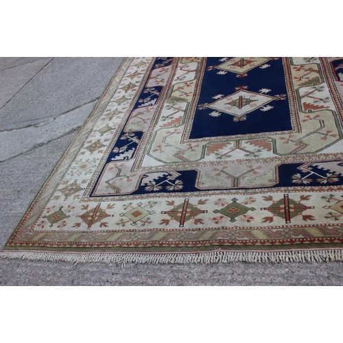 524 - A Caucasian wool pile carpet with central guls and geometric and floral designs, on a terracotta gro... 