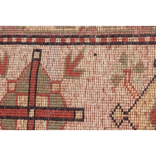 524 - A Caucasian wool pile carpet with central guls and geometric and floral designs, on a terracotta gro... 