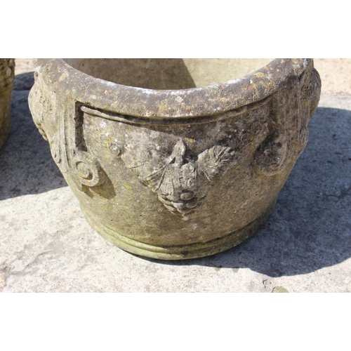 531 - A pair of cast stone planters with grape decoration, 15