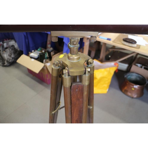 135 - A leather and brass cased telescope, on tripod