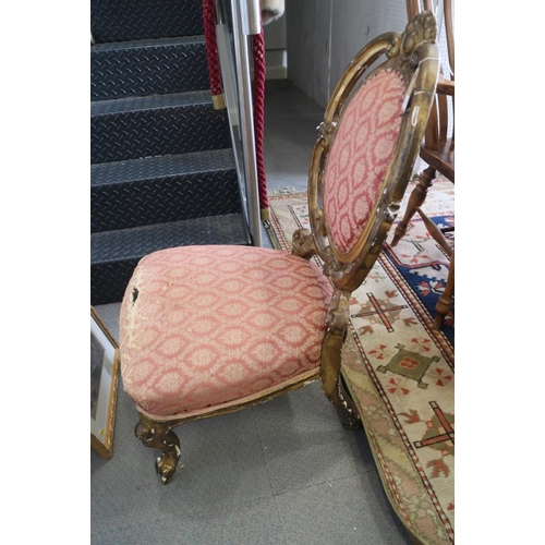 381 - A pair of French giltwood framed salon chairs with oval backs, upholstered in a pink brocade, on cab... 