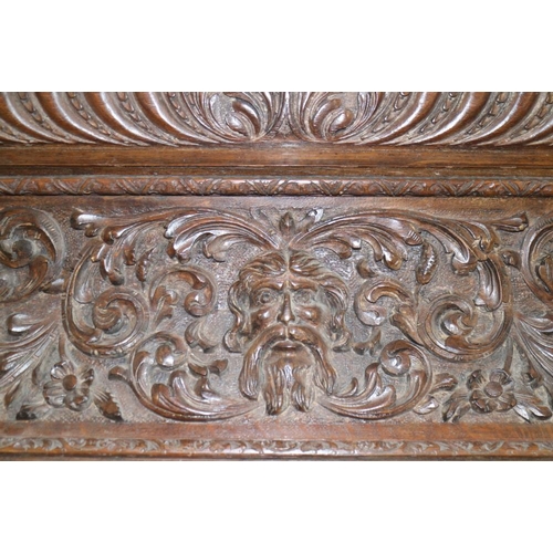 406 - A 19th century oak over-door moulding, carved gadroons, scrolls and central mask, 43