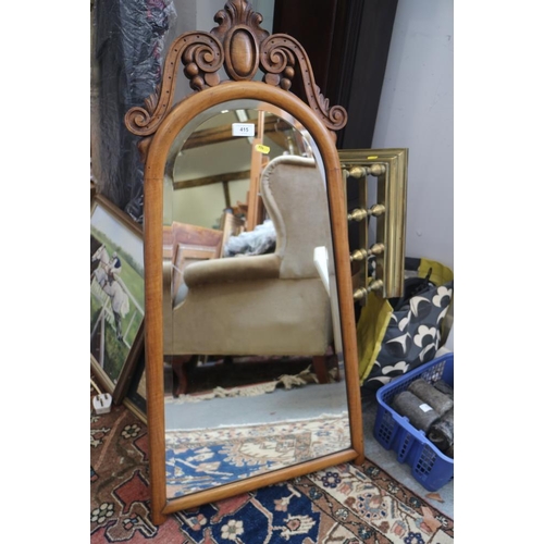 415 - A walnut framed tapering wall mirror with bevelled plate and scrolled decoration, 31 1/2