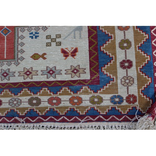 521 - An Aztec style rug with animal and geometric designs, 62