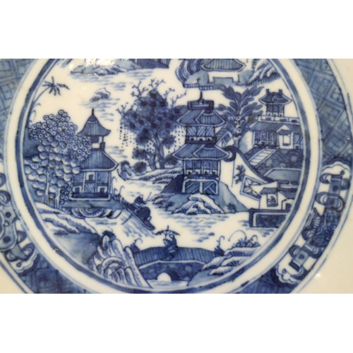 103 - A 19th century blue and white porcelain dish with lobed edge and central willow pattern panel, 10