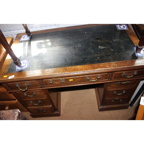 627 - An Edwardian oak double pedestal desk with tooled lined top, fitted nine drawers with brass handles,... 