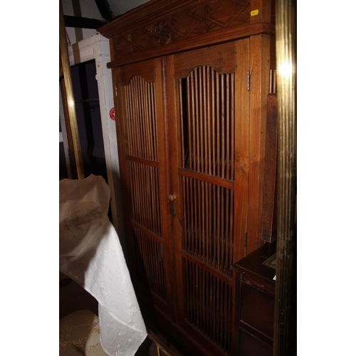 661 - An Indonesian teak cupboard enclosed two spindle decorated doors and drawer to base, 39