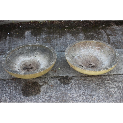 768 - A pair of cast stone circular shallow planters, 22