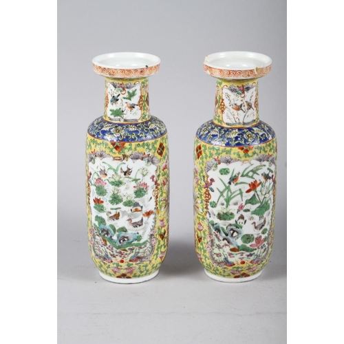 132 - A pair of Chinese cylinder vases, decorated polychrome panels with animals and flowers, 10