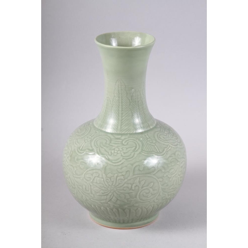 135 - A Chinese celadon bulbous vase with incised decoration and six character mark, 12