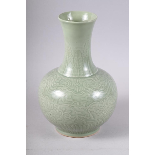 135 - A Chinese celadon bulbous vase with incised decoration and six character mark, 12