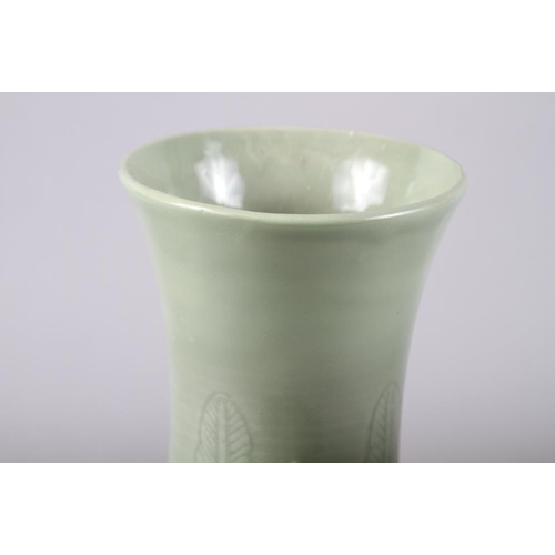 135 - A Chinese celadon bulbous vase with incised decoration and six character mark, 12