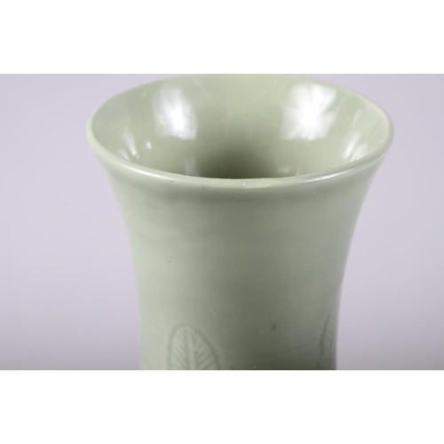 135 - A Chinese celadon bulbous vase with incised decoration and six character mark, 12