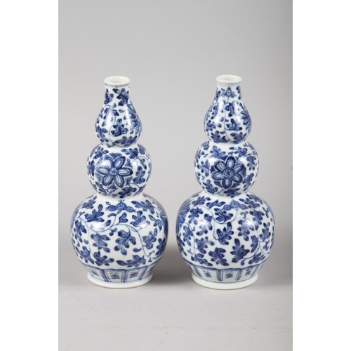 136 - A pair of Chinese blue and white triple gourd vases with floral decoration, 9 3/4