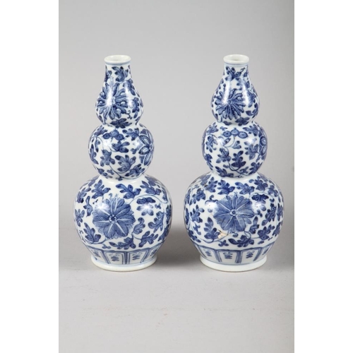 136 - A pair of Chinese blue and white triple gourd vases with floral decoration, 9 3/4