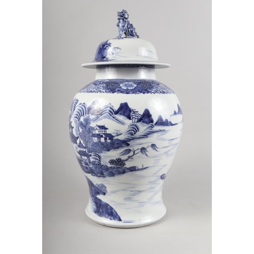 149 - A Chinese porcelain blue and white landscape decorated jar and cover with Dog of Fo finial, 17 1/2