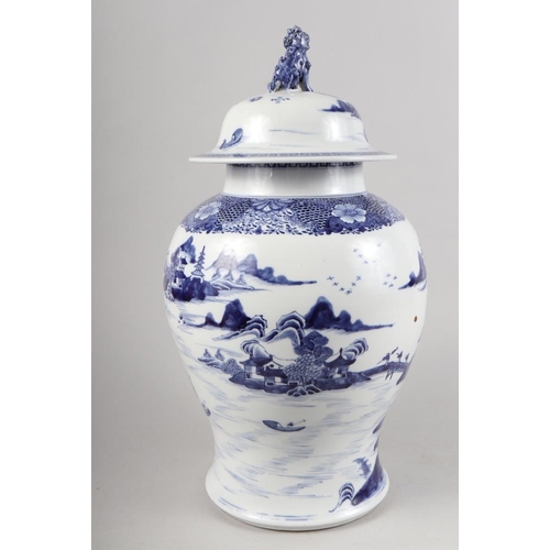 149 - A Chinese porcelain blue and white landscape decorated jar and cover with Dog of Fo finial, 17 1/2