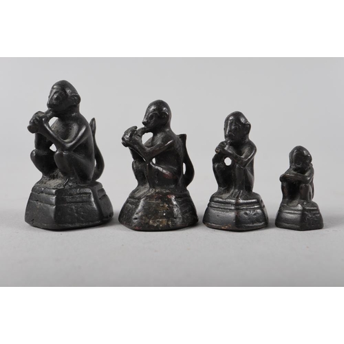 201 - A bronze set of paperweights in sizes, formed as seated monkeys, largest 2