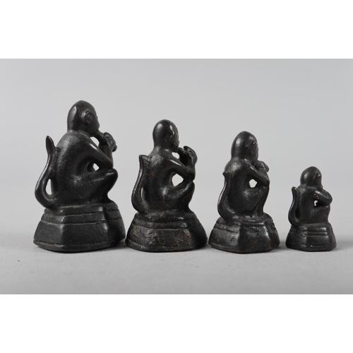 201 - A bronze set of paperweights in sizes, formed as seated monkeys, largest 2