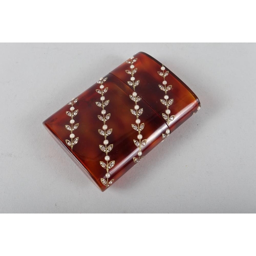 243 - A faux tortoiseshell cigarette case, inset pearls and paste stones, 3 1/2