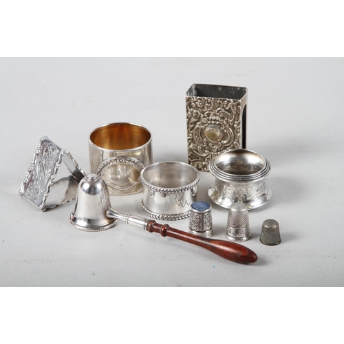 338 - A silver match box holder, a triangular-shaped napkin ring, two other silver napkin rings, a silver ... 