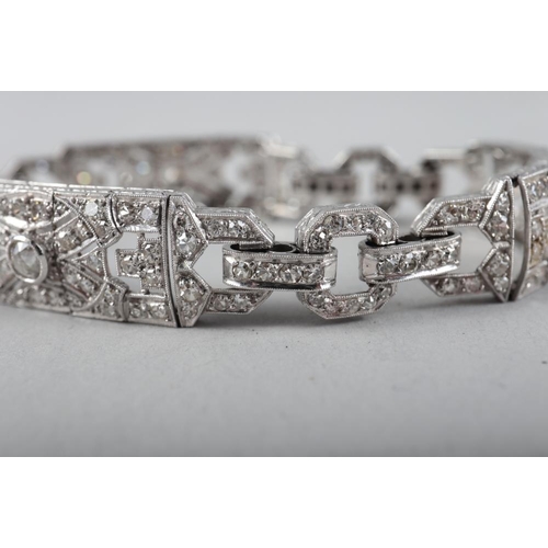 430 - An Art Deco white metal and diamond bracelet comprising three rectangular panels with chain links, 3... 