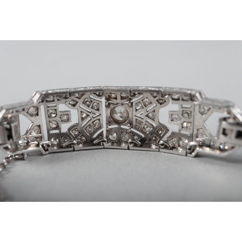 430 - An Art Deco white metal and diamond bracelet comprising three rectangular panels with chain links, 3... 