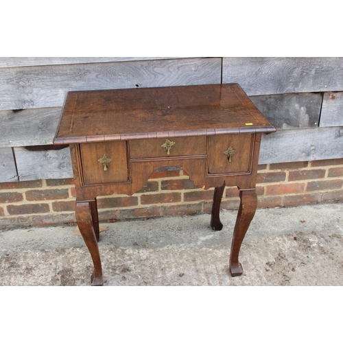 552 - A late 17th century/early 18th century oak lowboy, fitted three drawers over shaped kneehole, on cab... 