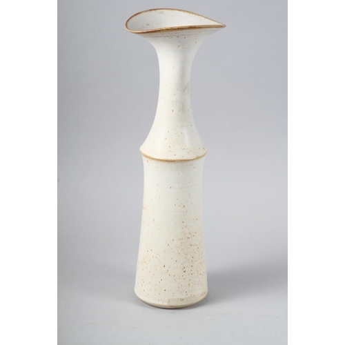 56 - L P: a cream glazed studio waisted vase with flared rim, 17