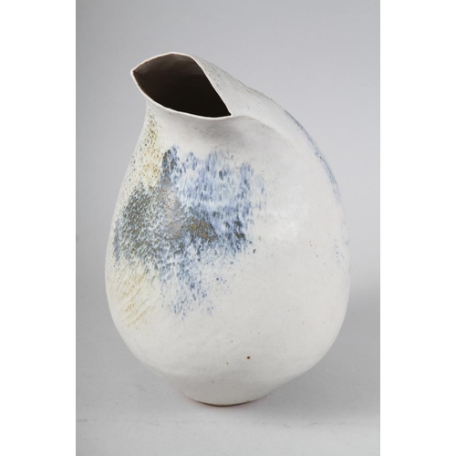 56 - L P: a cream glazed studio waisted vase with flared rim, 17