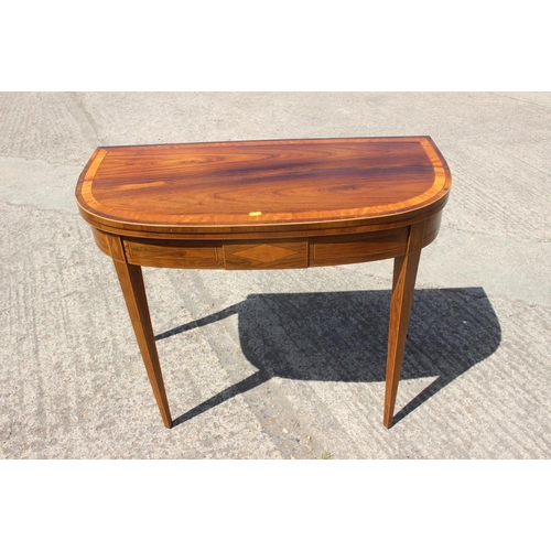 560 - A late Georgian rosewood and satinwood banded fold-over top card table, on square taper supports, 36... 