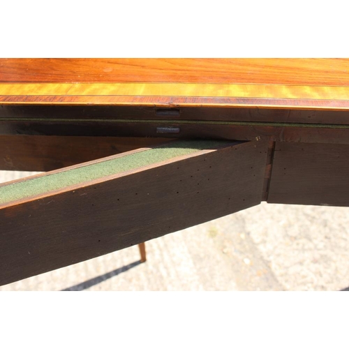 560 - A late Georgian rosewood and satinwood banded fold-over top card table, on square taper supports, 36... 