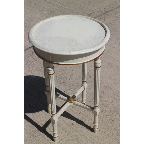 623 - A white and gilt painted circular top occasional table, on reeded supports