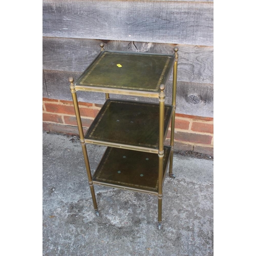 631 - * A brass framed three-tier etagere with green tooled leather inset tops, 12