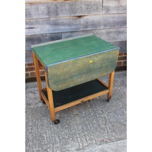 638 - A painted hardwood two-tier tea trolley with flap top, 18