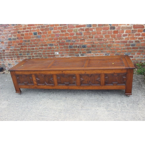 642 - An oak coffer with 17th century design panel front, on Sheppard castors, 83