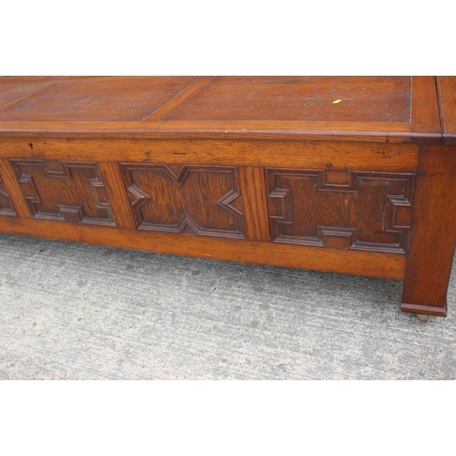 642 - An oak coffer with 17th century design panel front, on Sheppard castors, 83