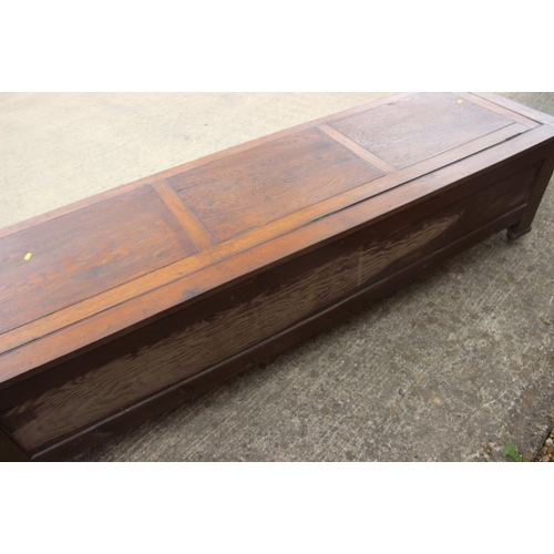 642 - An oak coffer with 17th century design panel front, on Sheppard castors, 83