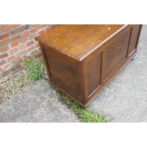 643 - An oak coffer with triple panel front, on Sheppard castors, 39