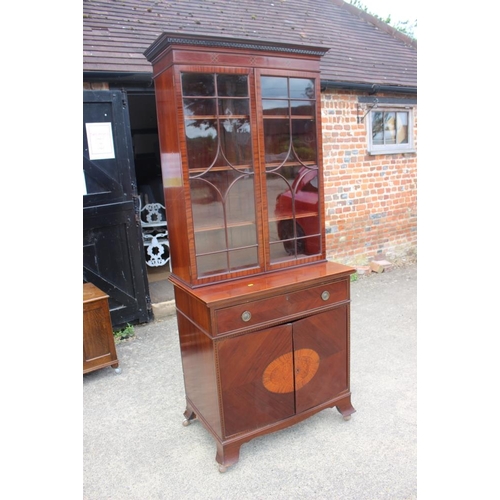 644 - A mahogany and box line inlaid bookcase, the upper section enclosed lattice glazed doors over one dr... 